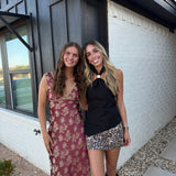 BLACK ASYMMETRICAL GOLD HARDWARE HALTER TOP